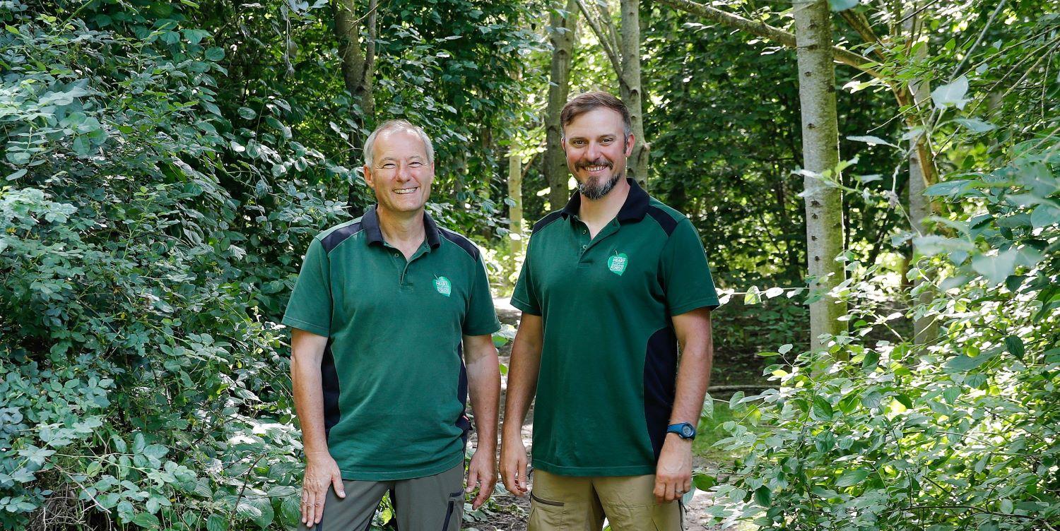 Tree nursery staff Geza and Ian standing together smiling in the Forest